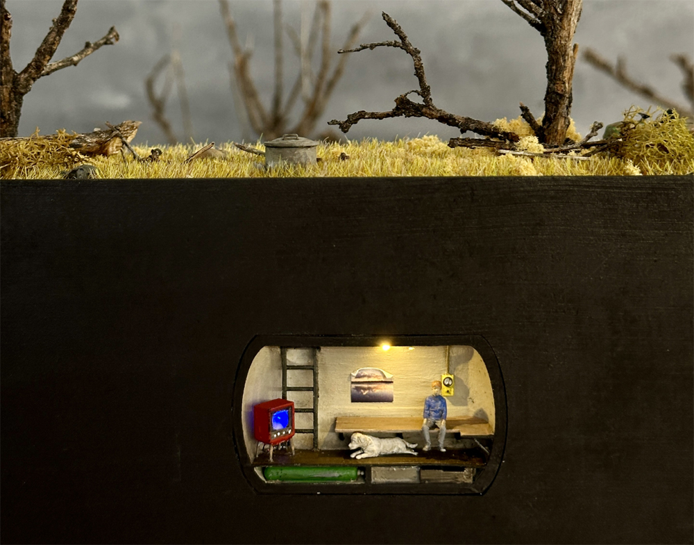 A model bomb shelter underneath a model railroad layout