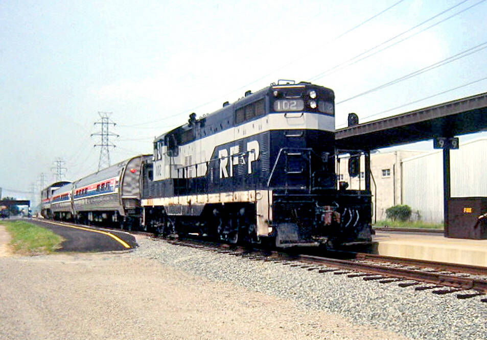 blue and white locomotive on track
