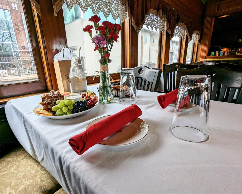 table in train with food and flowers