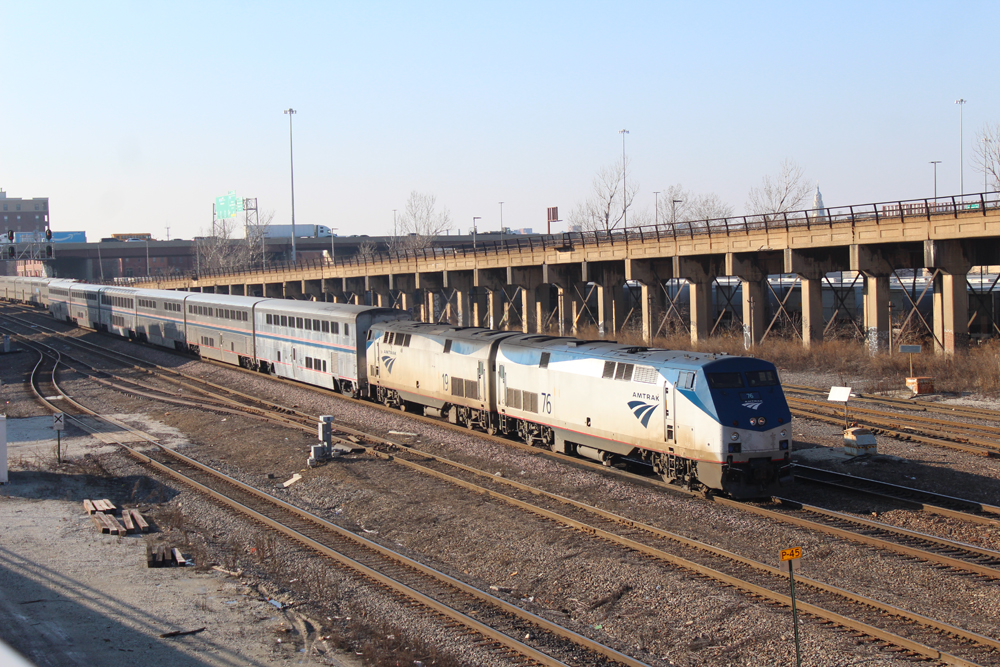 Passenger train with two locomotives and bilevel cars on multi-track main line