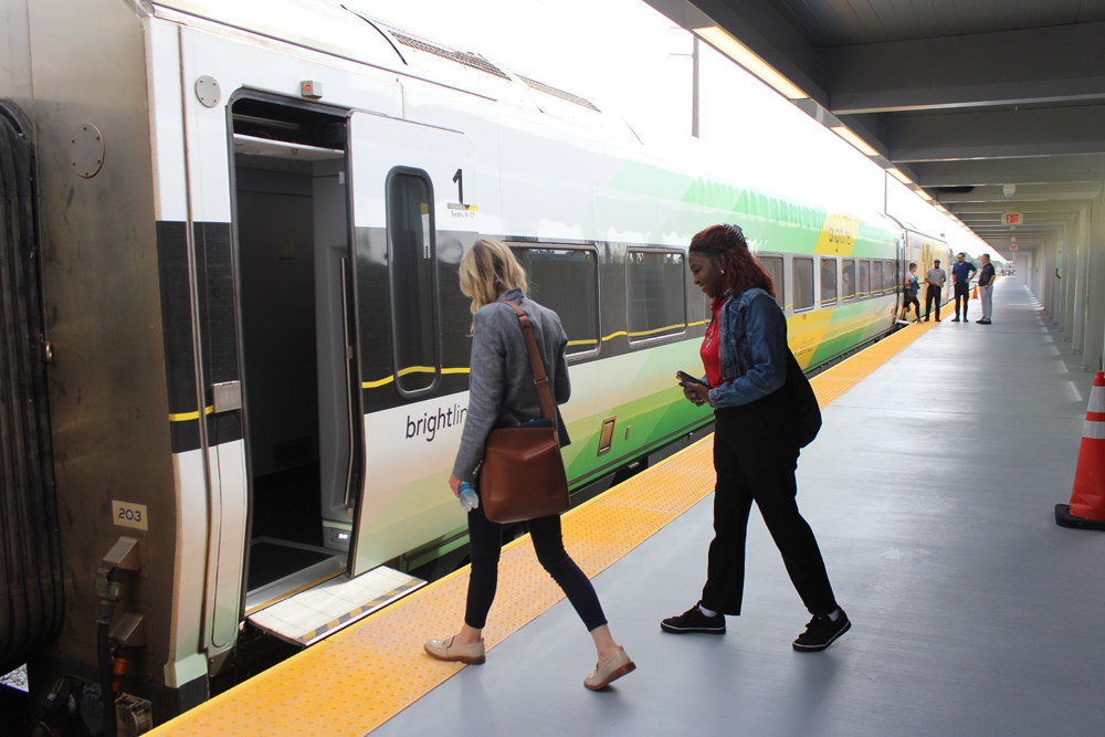 Two people boarding passenger train