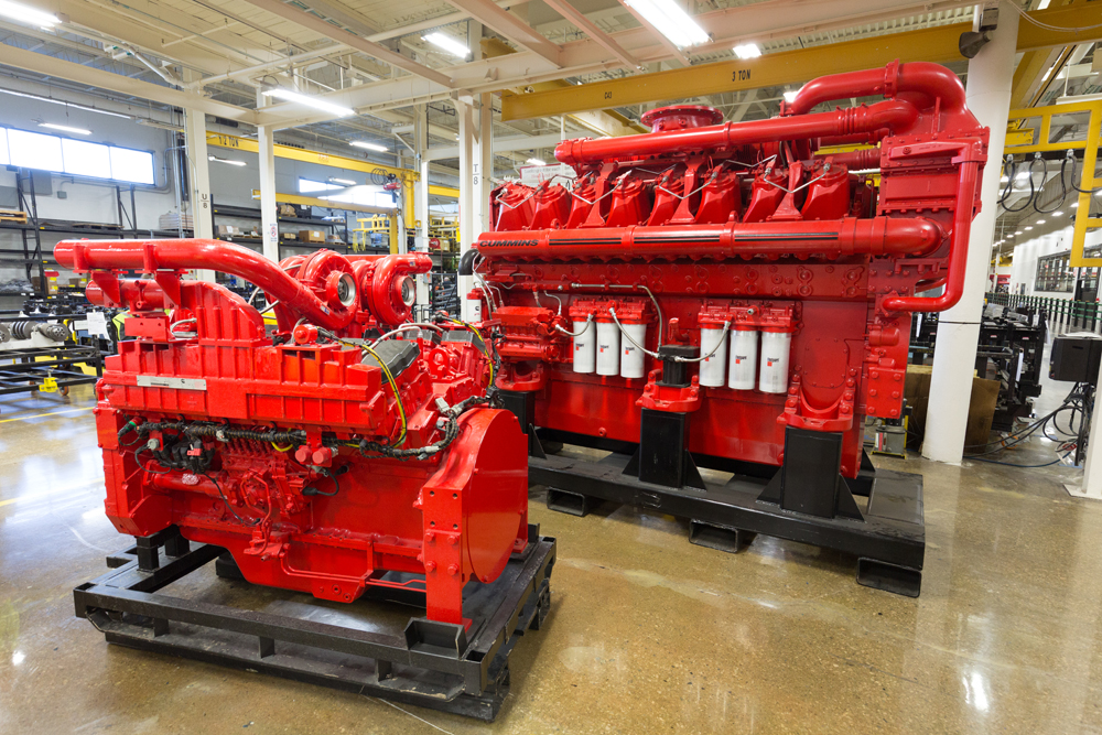 Two red diesel engines on factory floor