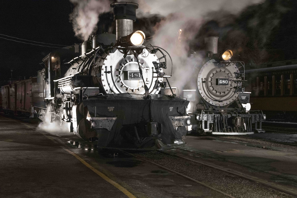 Two steam locomotives at night