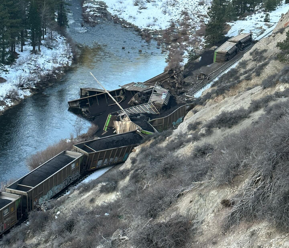Derailed coal hoppers in canyon, some in river