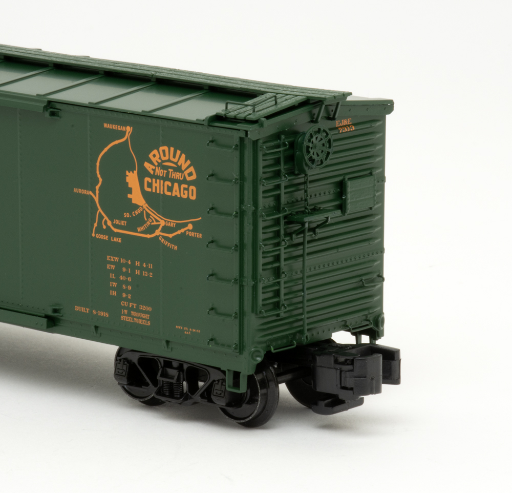 Color photo showing B end details on S gauge boxcar painted green with orange graphics.