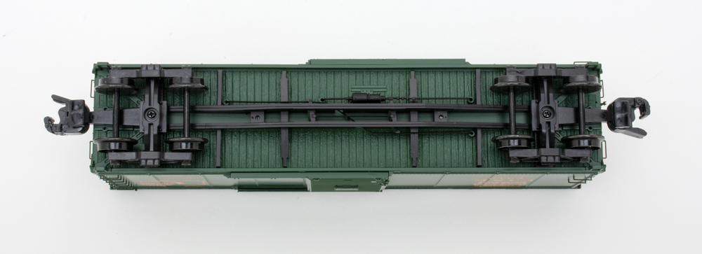 Underbody detail on S gauge boxcar painted green with black trucks and underbody detail.