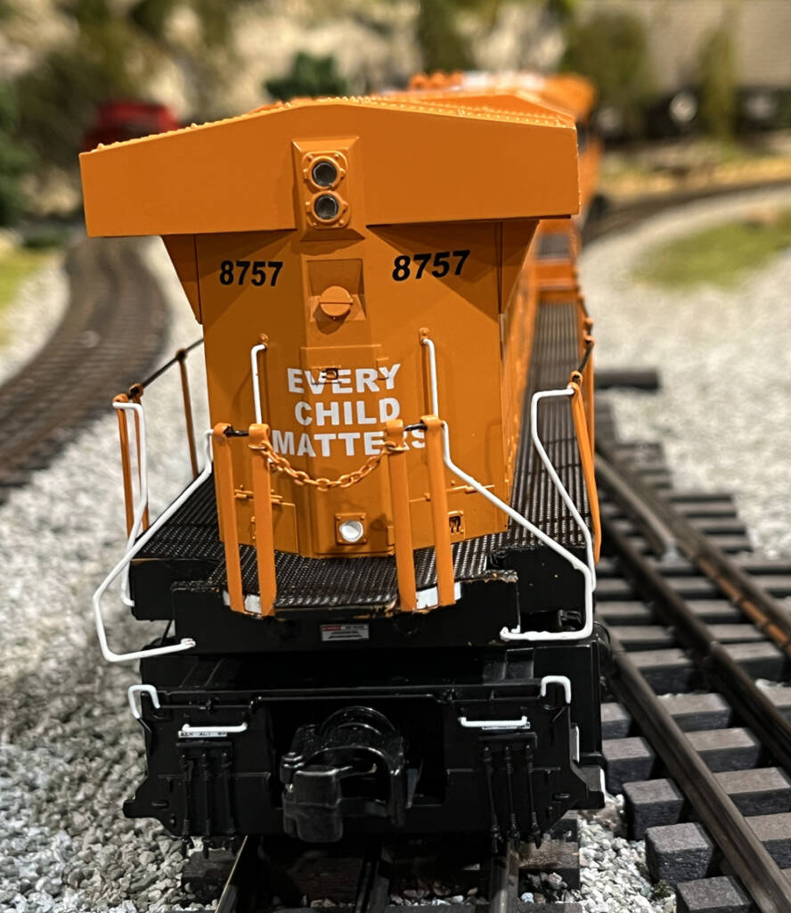 rear of orange and black model train