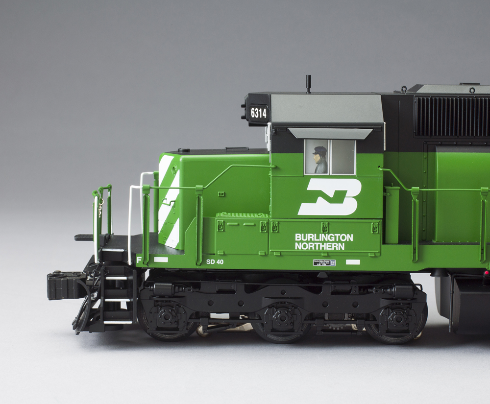 side of green and white model locomotive