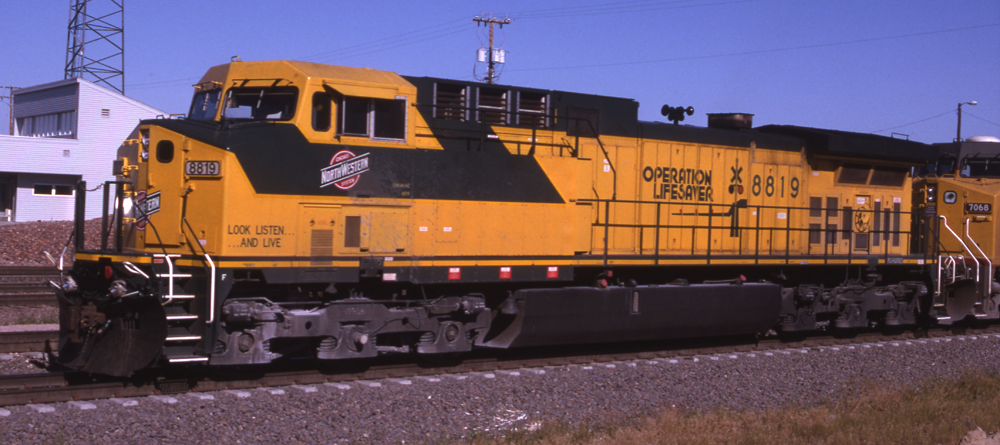 Color prototype image of six-axle road locomotive painted green and yellow.