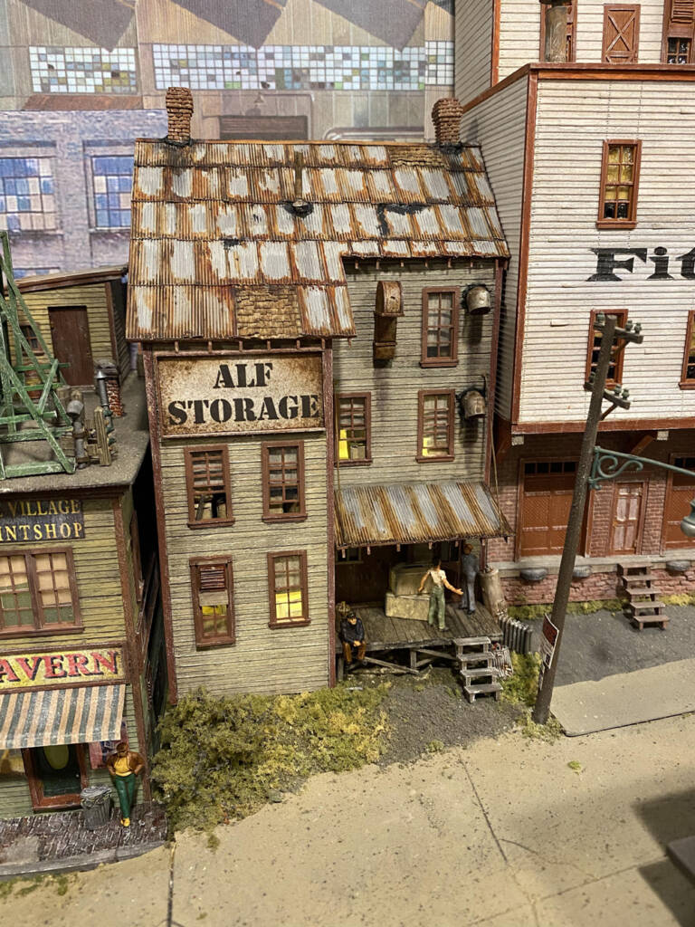 Color photo of weathered structure on a model railroad.