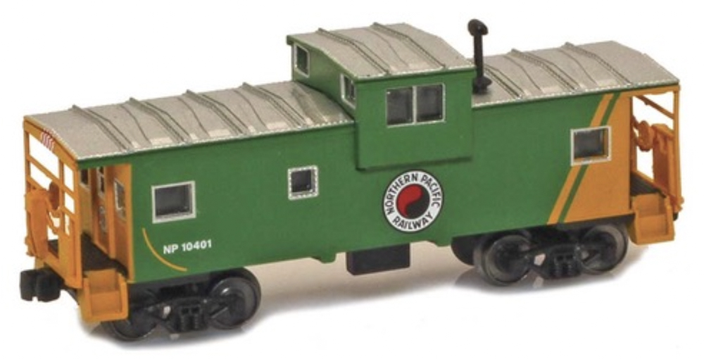 A model caboose in a green and yellow paint scheme