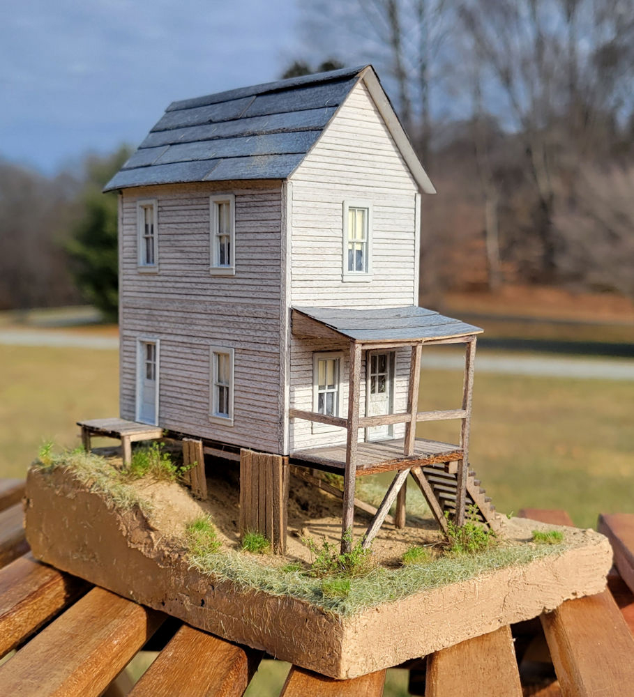 A model house structure with scenery