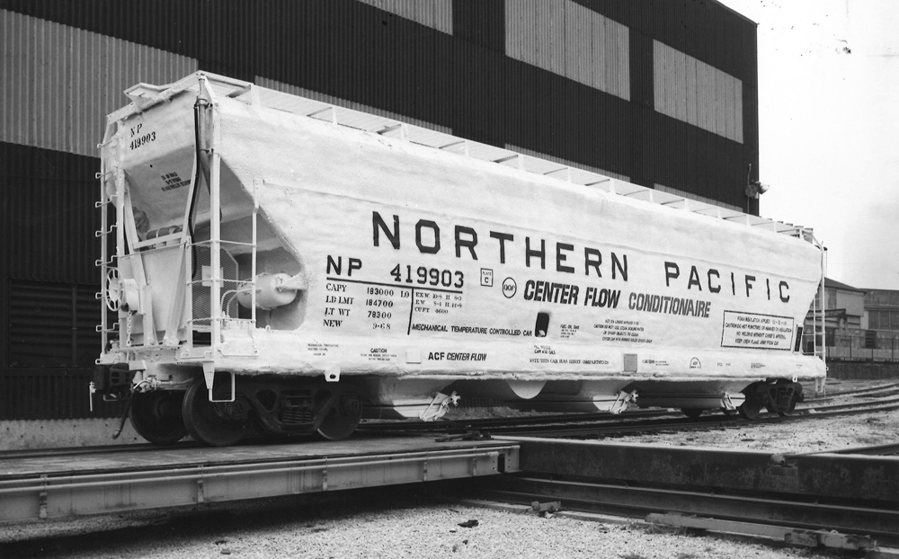 Black-and-white image of three-bay covered hopper.
