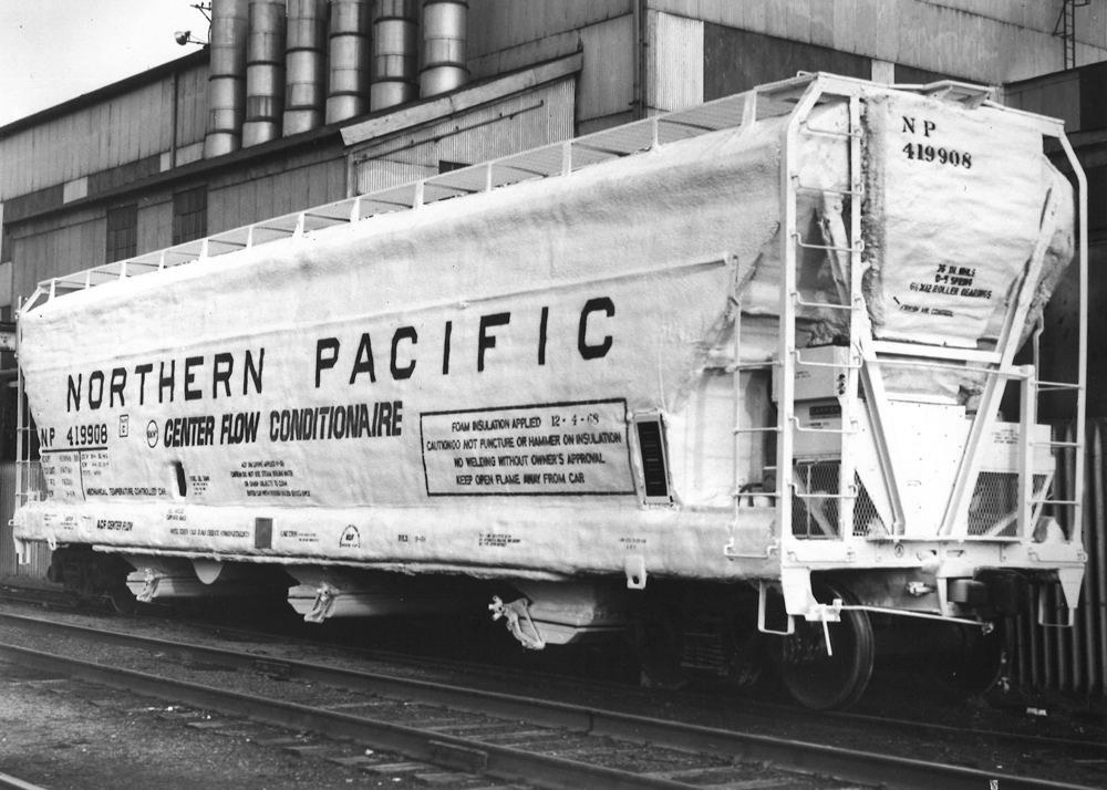 Black-and-white photo showing A end of three-bay covered hopper.