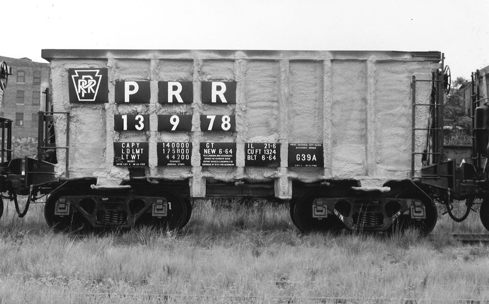 Black-and-white image of freight car with spray-on foam coating.