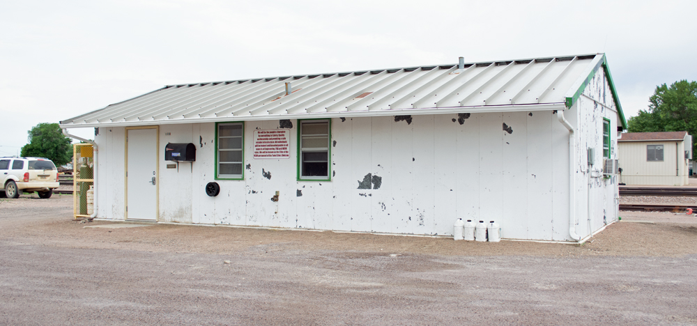 Color photo showing side of metal yard office building.