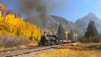 A narrow-gauge Mikado steam locomotive in a colorful mountain setting. Trains LIVE – Mikados