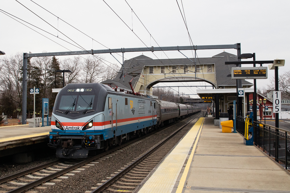 Amtrak train with a wrap on tracks