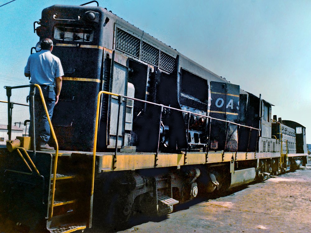 man standing in front of black locomotive on landing