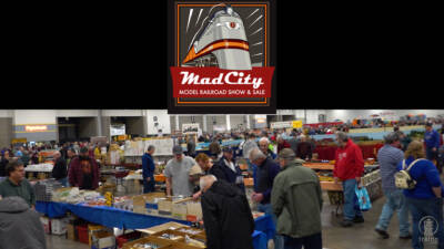 Exhibit hall set up for a train show with people looking at exhibits