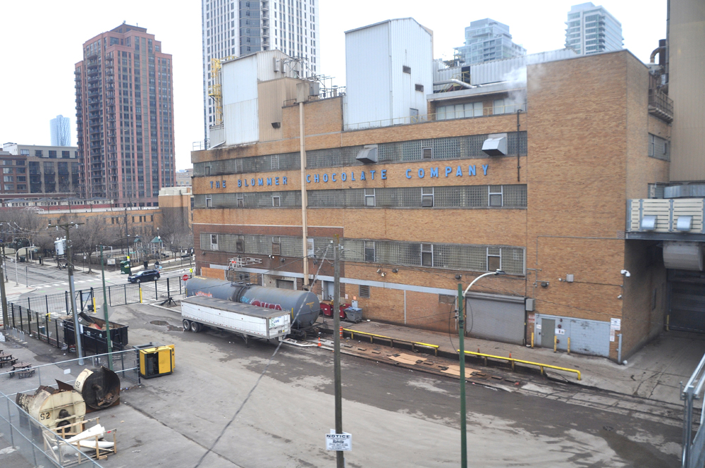 Tank car outside brick factory building