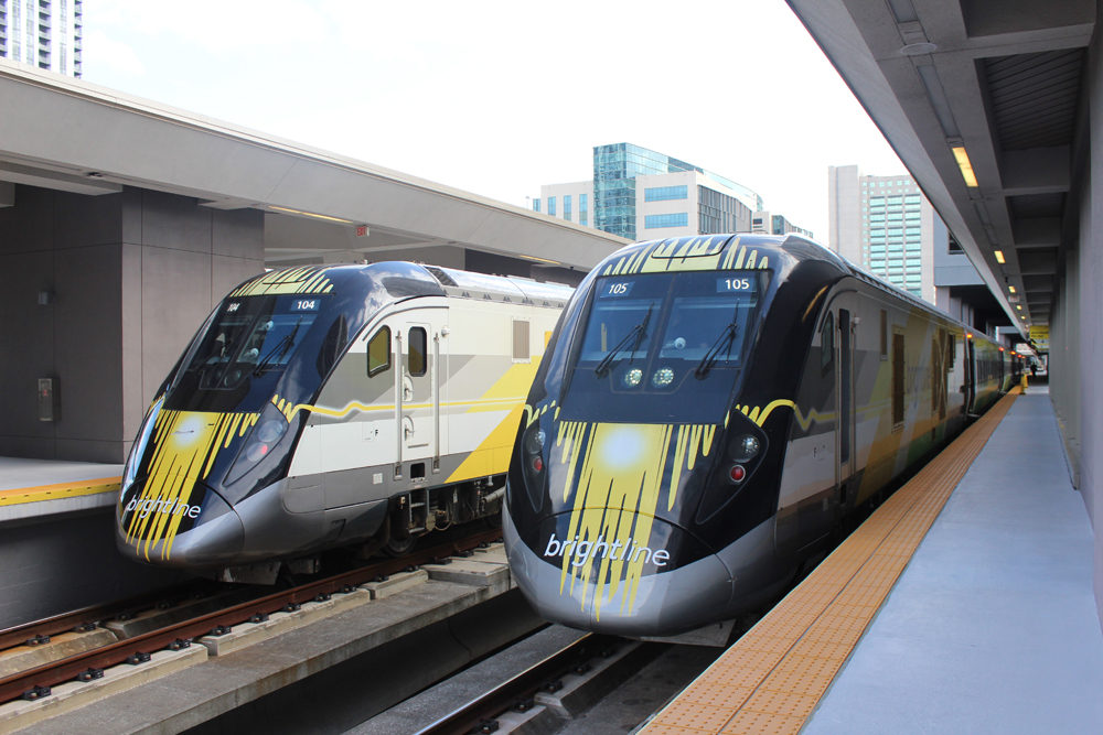 Two Brightline trains at station