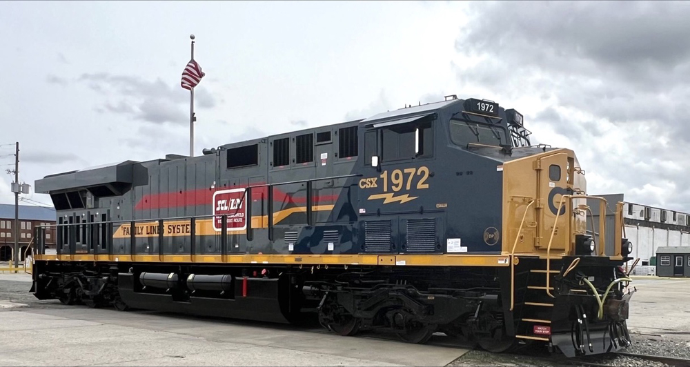 CSX locomotive with gray, yellow, and red long hood