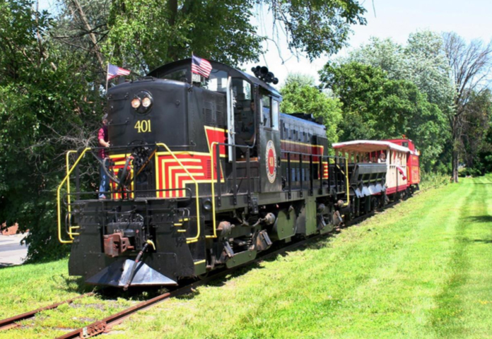 Black locomotive with short tourist train