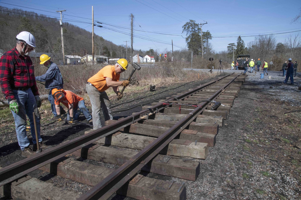 Men working to rebuild railroad track