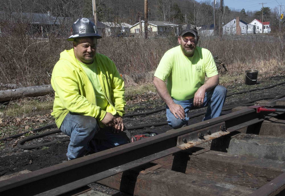 Two guys posed on railroad track