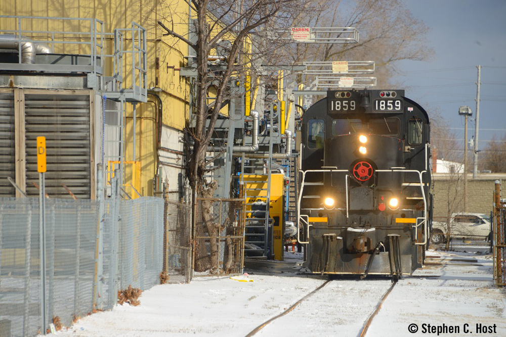 Front view of black locomotive on industry spur