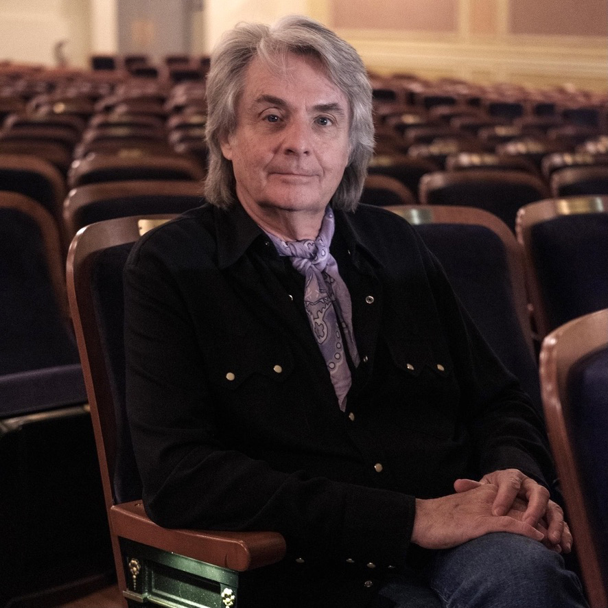 Man sitting in seats in otherwise empty theater