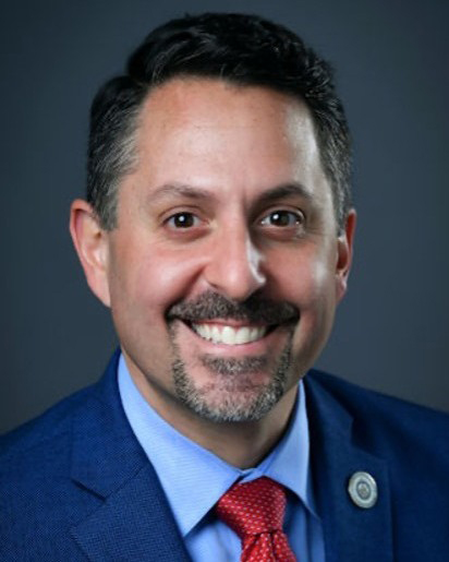 Smiling man in coat and tie