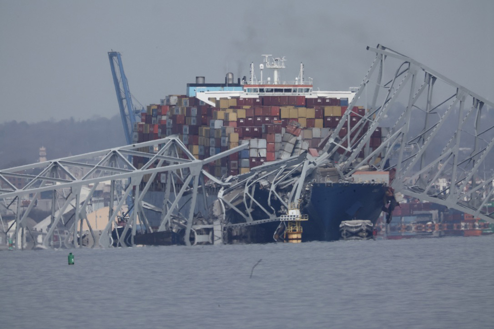 Metal wreckage and container ship
