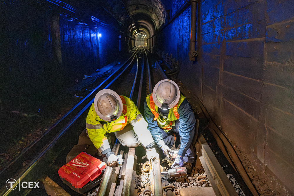 Crew works on track in subway tunnel