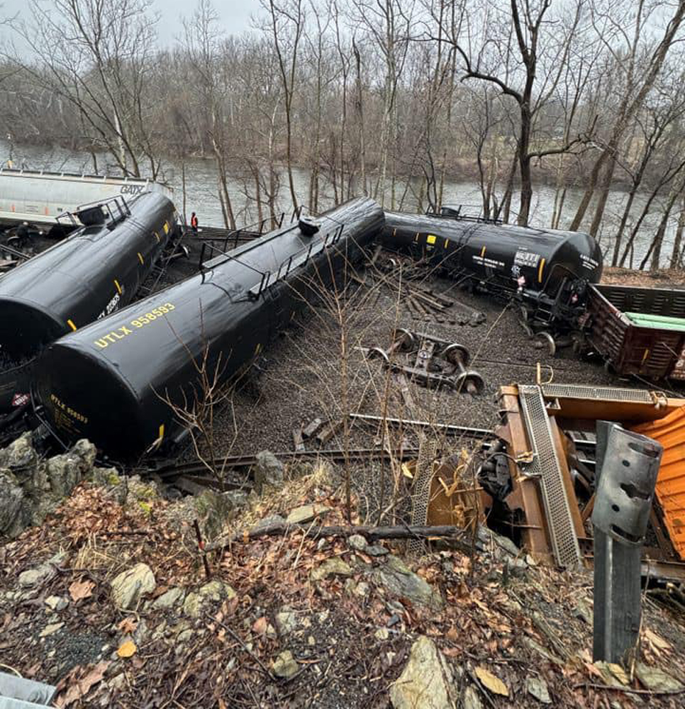 Derailed tank cars next to river