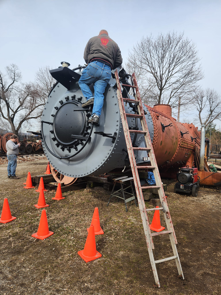 Man on ladder working at front of locomotive