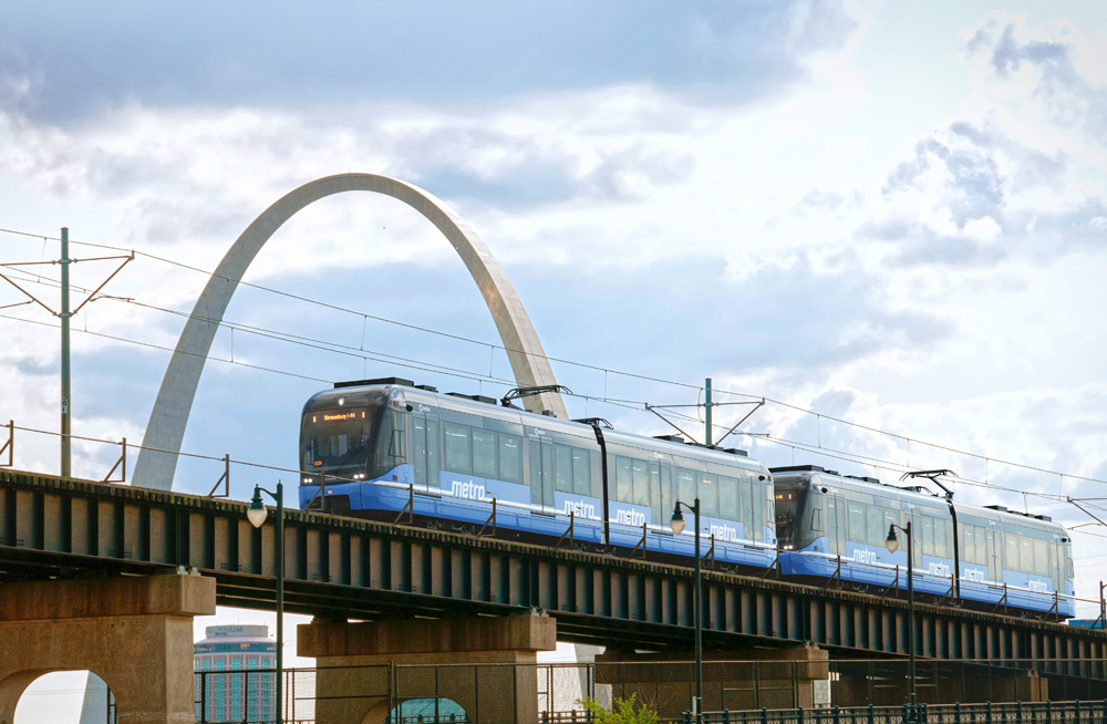 Light rail vehicles with Gateway Arch in background