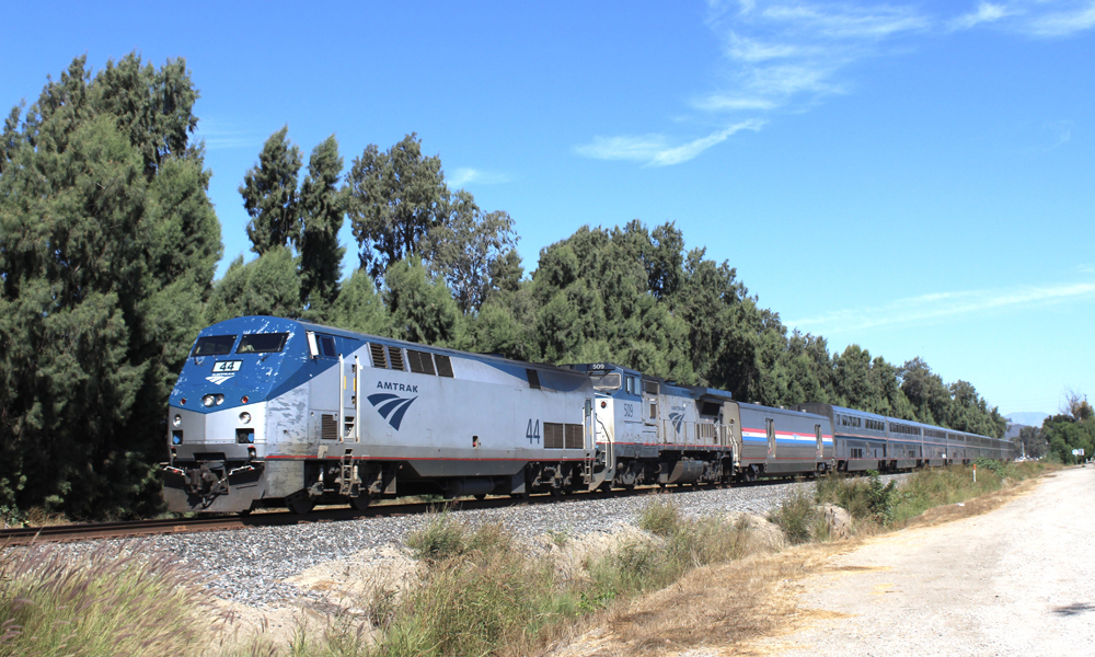 Passenger train on track paralleling road