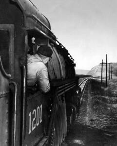 Man looking down boiler of steam locomotive from new book Thirteen Scoops Around the Box