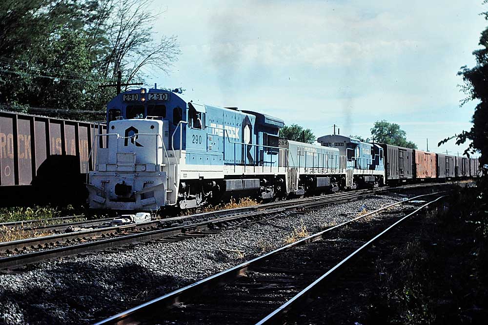 Blue-and-white diesel Rock Island locomotives on freight train