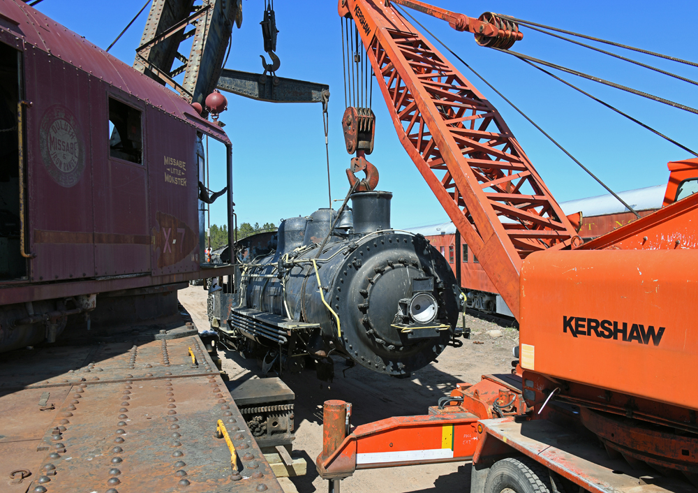 Cranes move part of steam locomotive