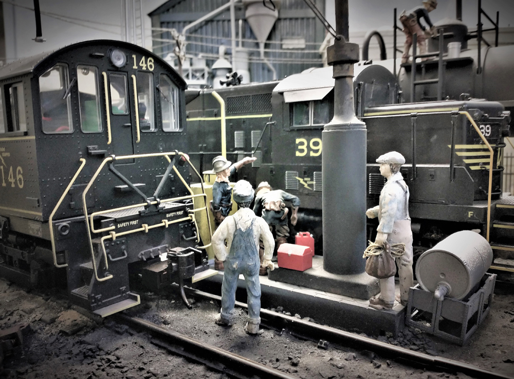 sepia toned photo with model engine and figures