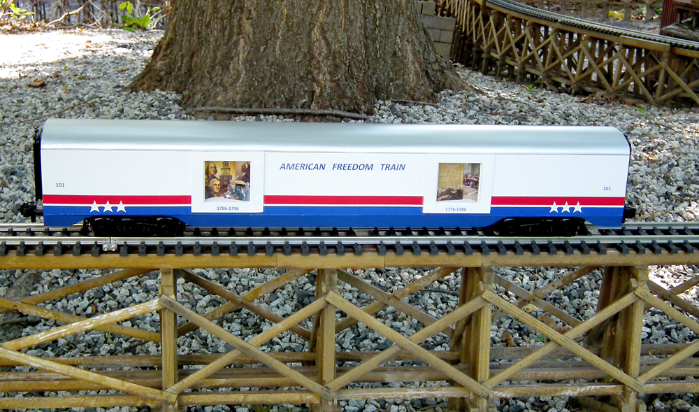 red, white, and blue car on trestle