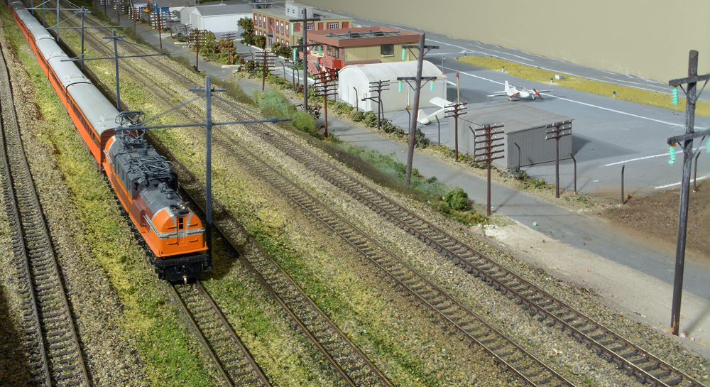 Color photo of train passing an airport on N scale layout.