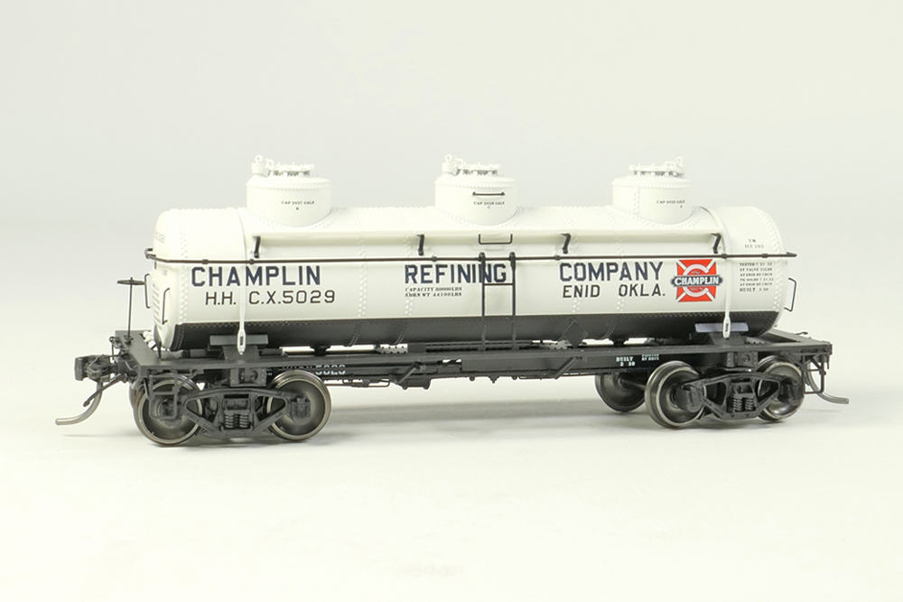 A model tank car in a white paint scheme with black lettering
