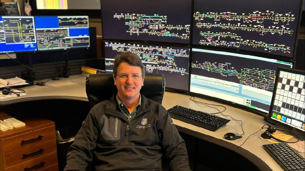 Man seated by railroad computer dispatching screens. Guardian Award honors Union Pacific dispatchers