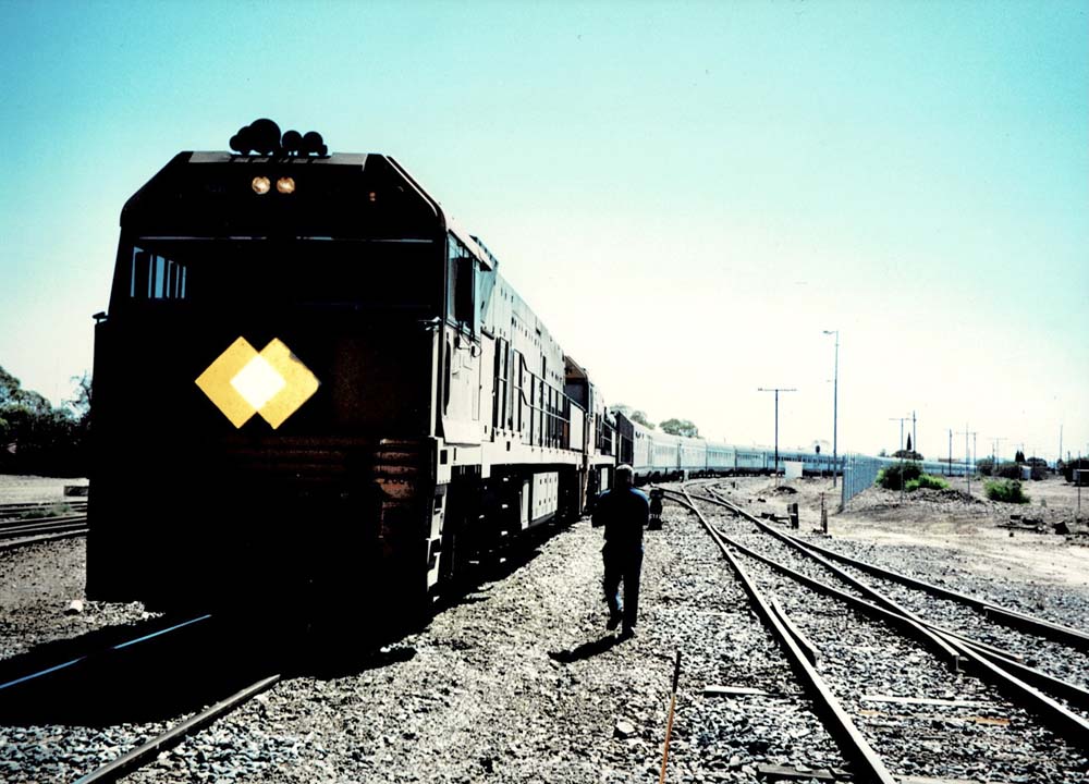 back of train with man walking next to it