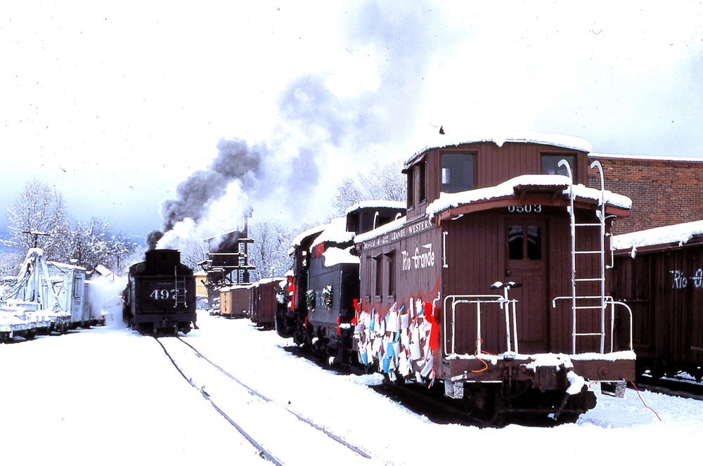 several units on tracks in snow with steam coming up