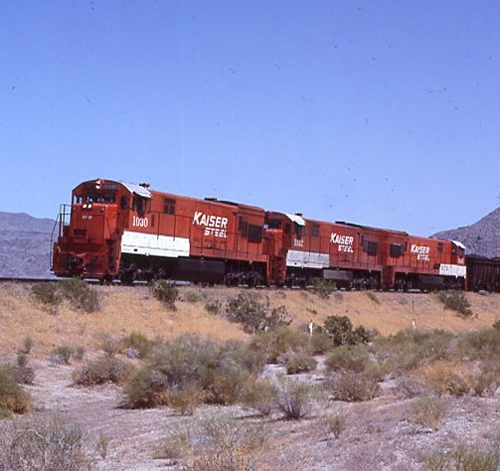 red and white locomotive in the desert
